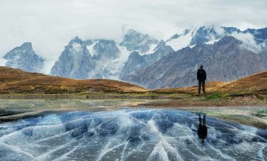 Landscape on mountain frozen lake Koruldi. Upper Svaneti, Georgia, Europe. Caucasus